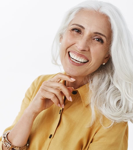 A smiling woman after taking a dental implant treatment