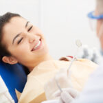Image of smiling patient looking at the dentist